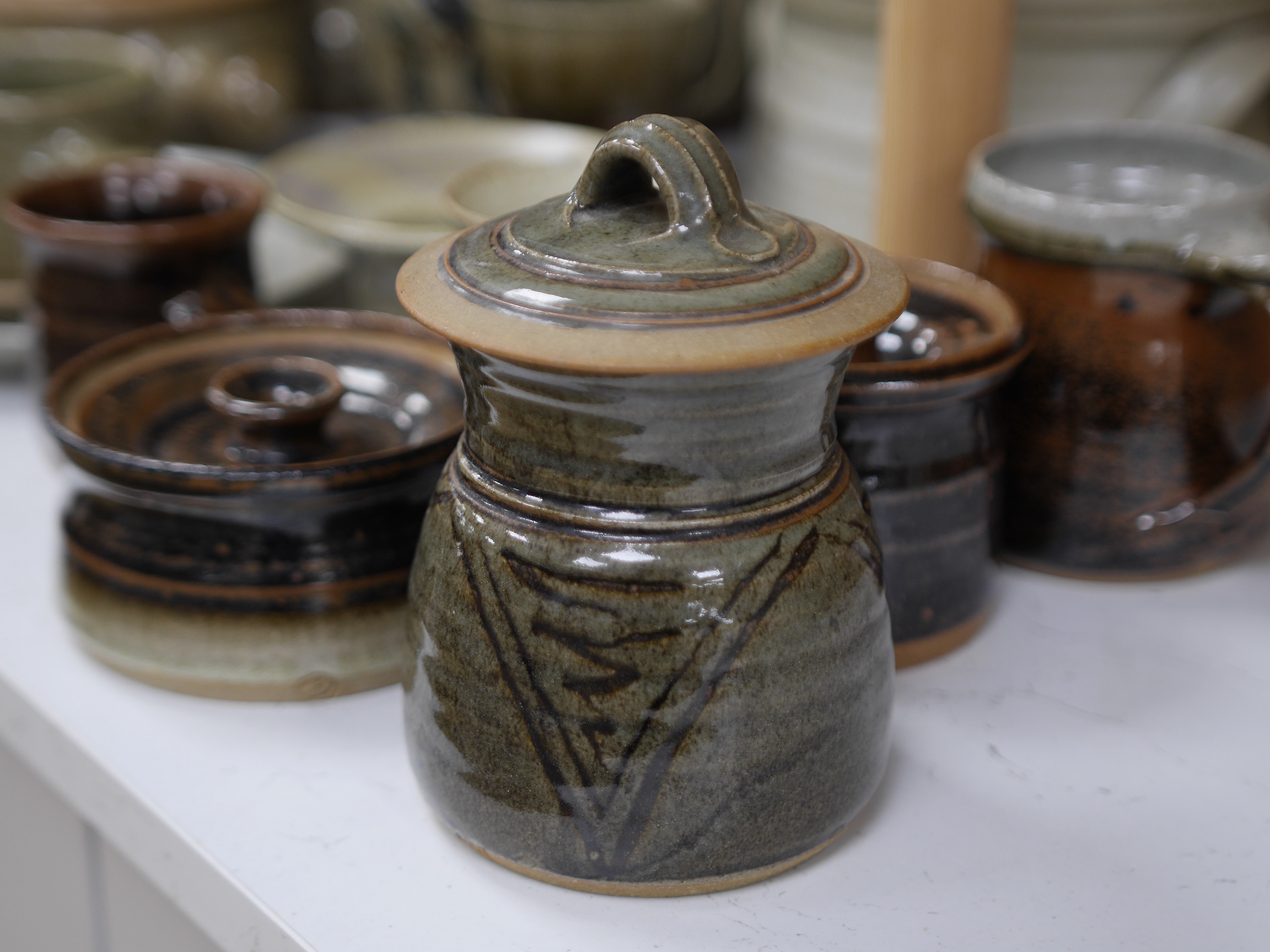 A large collection of Studio ceramics by John Davidson, Truro Pottery, largest item casserole pot and cover 20cm high (31). Condition - teapot has cover missing, but rest mostly good